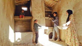 Life in the mountains: Cementing the floor of the shelter by a kind man and nomadic girls