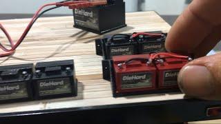 3d printed scale batteries with jumper cables, wood crates, leg tanks