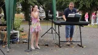 Madison singing at Musikuk's Party in the Park 2014