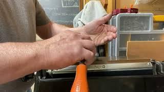 Sharpening chisels on a whetstone.