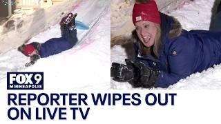 Reporter wipes out while sledding on live TV