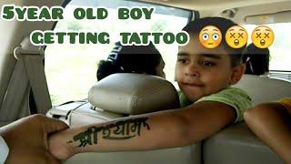 5year old boy getting tattoo 