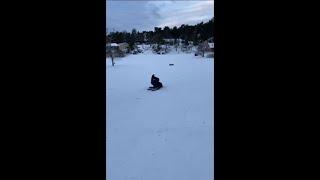 Guy Jumps Up Snow On A Sled But Lands Face First
