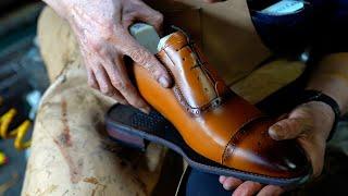 Handmade shoes craftsman with 50 years of experience. Process of making brown shoes