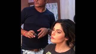 Zareen Khan appraising Ajay Shelar 's makeup skills