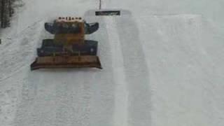 Snowboarder Jumps Over Groomer