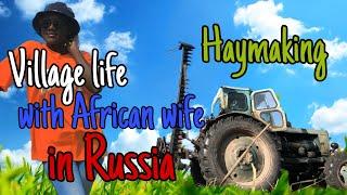 African wife in a Russian village  Haymaking