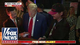 Watch: Trump makes transaction with Bitcoin at NYC bar