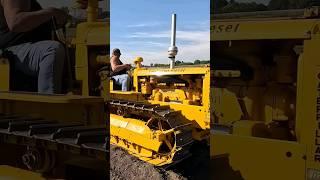 A 1950 Caterpillar D2 pulling a grader.