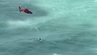 USCG aircrew rescues man clinging to a cooler (B-Roll)