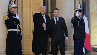 Donald Trump is greeted by Emmanuel Macron at the Elysee Palace | AFP