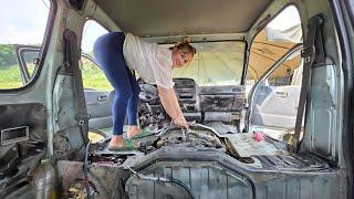 The girl repaired and maintained the old scrap car.