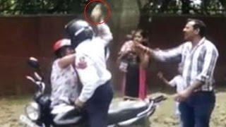 Delhi Traffic Cop attacks woman with brick