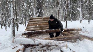 Building a Mini Shelter in a Snowy Ice Forest. Laying And Insulation Of Log Walls