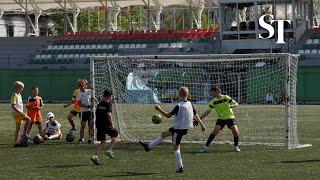 Ukrainian kids play football in bombed-out stadium