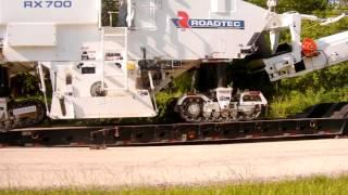 Roadtec being loaded on to a lowboy.