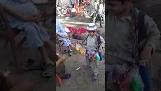 Poor little kid selling toy in the streets at Karachi, pakistan