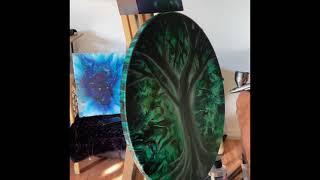 Airbrushing An Emerald Forest on canvas with acrylic pour.