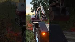 Loading  the Takeuchi TB240 excavator with the new thumb on a new tilt trailer.