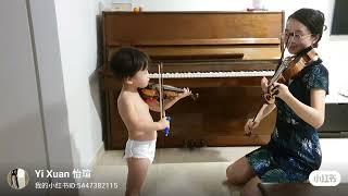 2 year old boy plays violin with mom