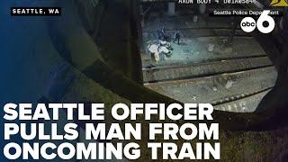 CAUGHT ON CAMERA: Seattle police officer pulls man away from oncoming freight train