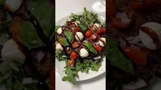 Chicken Milanese with arugula, tomato and balsamic glaze.