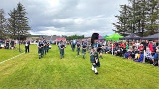 Mace flourish from Drum Major leading Towie Pipe Band march 2024 Dufftown Highland Games in Scotland