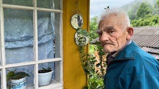 Happy old age of an elderly couple of shepherd in a mountain village far from civilization