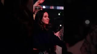 Crowd holding hands and dancing