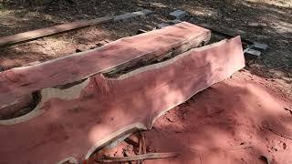 Cutting redwood cedar logs into slabs with homemade sawmill