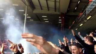 Everton fans setting off blue smoke bombs at Anfield