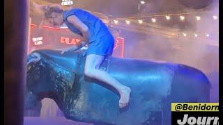 Girl in Blue Denim Dress Riding on a Mechanical Bull in Benidorm 4K