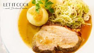 Roast pork with potato dumplings and bacon cabbage salad