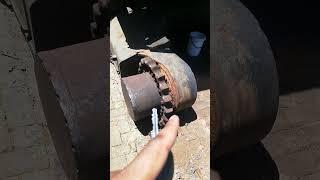 EXCAVATOR'S WHEELS AFTER REMOVING TRACK CHAINS USING CUTTING TORCH IN MECHANICAL WORKSHOP