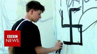 Berlin street artist group cleverly undo swastika graffiti- BBC News