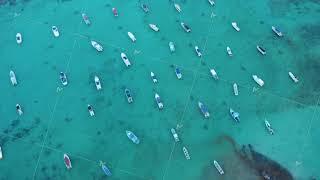 Top down view with boats moored in the turquoise water