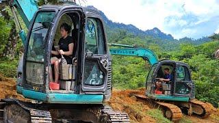 the driver and the girl Driving an excavator to open the logging path.