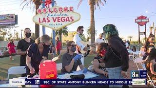 Locals, visitors roll up their sleeves for COVID vaccinations at world-famous sign