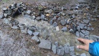 Mucking out a drainage ditch to solve driveway flooding issues