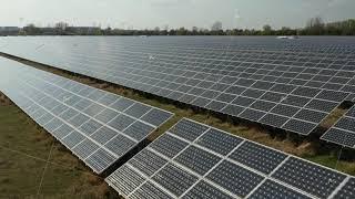 AERIAL: Close Up Flight over Solar Panels that produce Green, Environmentally friendly Energy from