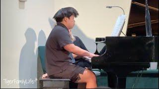 WRESTLER PLAYING PIANO AT RECITAL