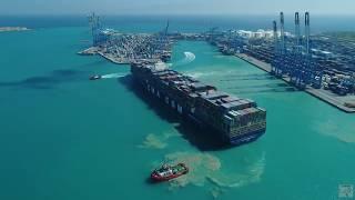 Aerial Drone Footage of Tugboats Mooring a Huge Container Ship