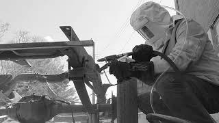 Sand blasting a frame.