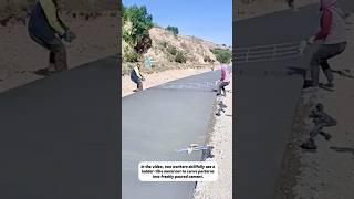 A Dance on Cement – Two Workers, One Patterned Net.