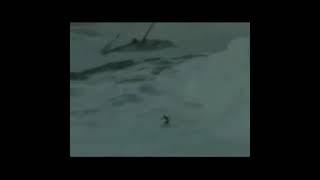 Man surfs in tsunami (edit)