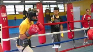 Alejandro Cepero 12 year old (yellow t-shirt) boxing with 18 year old boxer (white t-shirt)