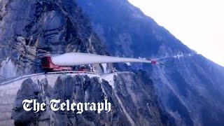 Moment wind turbine blade is carried up steep mountain slope in China