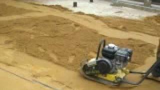 Sharp sand being compacted for block paving driveway