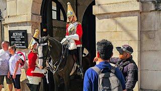 POLICE TELL CHINESE TOURIST TO WAIT UNTL HE CAN APPROACH THE GUARD AND HORSE at Horse Guards!