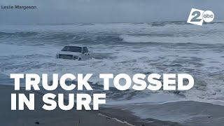 Truck trashed in surf at Pacific City beach